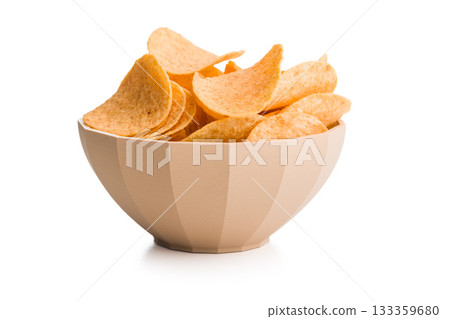 Crispy potato chips in bowl isolated on white background. 133359680