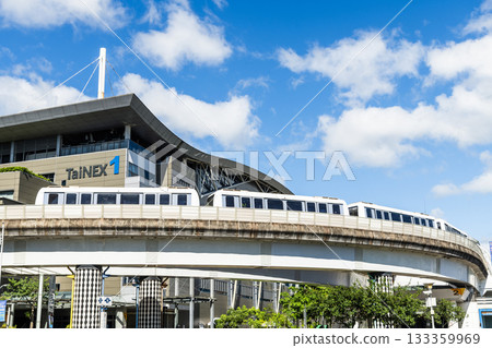 A train on the Wenhu or Brown Line of the Taipei MRT passes by the Taipei Nangang Exhibition Center Hall 1. A train on the Wenhu or Brown Line of the Taipei MRT passes by the Taipei Nangang Exhibition Center Hall 1. 133359969