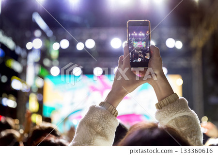 Audience filming the concert hall 133360616