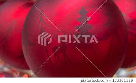 Matte red Christmas ornament with a minimalist silhouette of deer and pine trees Matte red Christmas ornament with a minimalist silhouette of deer and pine trees 133361189