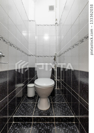 Modern Bathroom Interior with White Toilet and Tile Walls 133362038