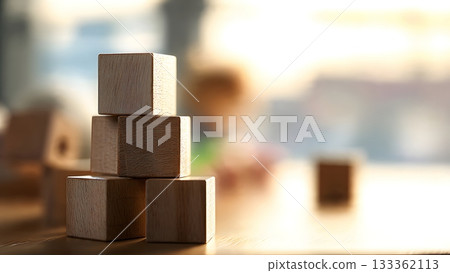 Close-up focus on a stack of simple wooden cubes on a table, symbolizing early education, construction, and childhood development with a child blurred in the background. AI Generated Close-up focus on a stack of simple wooden cubes on a table, symbolizing early education, construction, and childhood development with a child blurred in the background. AI Generated 133362113