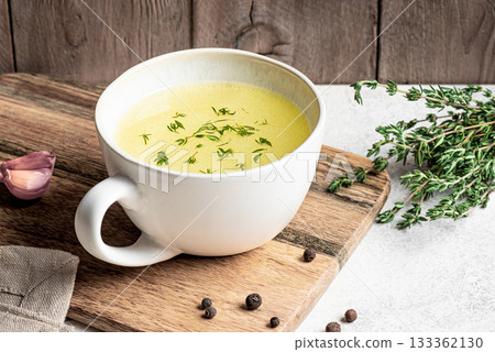 Hot healing bouillon (chicken bone broth) with herbs 133362130