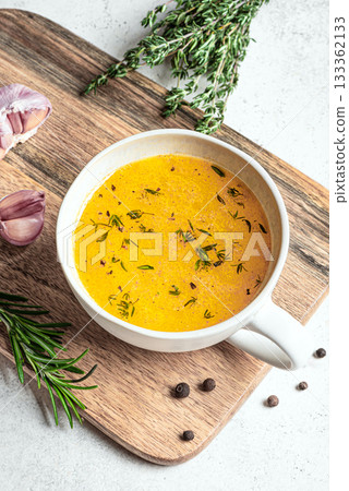 Beef bone broth with herbs in mug Beef bone broth with herbs in mug 133362133