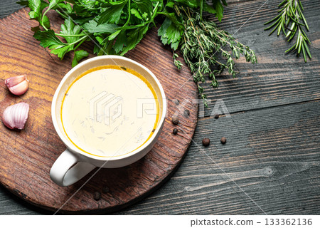 Beef bone broth with herbs in mug Beef bone broth with herbs in mug 133362136
