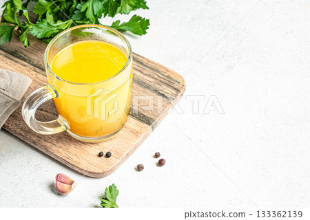 Beef bone broth with herbs Beef bone broth with herbs 133362139