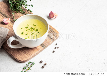 Hot healing bouillon (chicken bone broth) with herbs 133362144