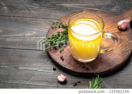 Beef bone broth with herbs in cup 133362149