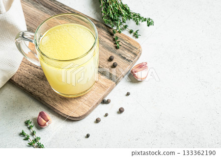 Hot healing bouillon (chicken bone broth) with herbs 133362190