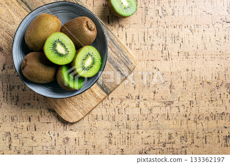 Kiwi fruits in wooden bowl Kiwi fruits in wooden bowl 133362197
