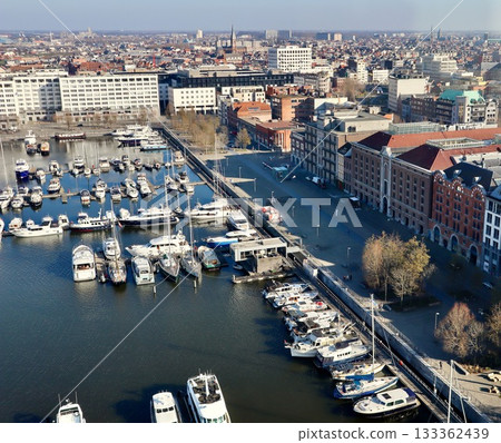 Antwerp city waterfront marina aerial view, boats moored along the docks, historic architecture in background Antwerp city waterfront marina aerial view, boats moored along the docks, historic architecture in background 133362439