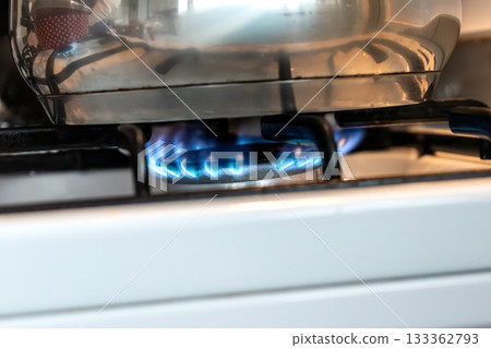 Saucepan on gas stove, gas cooker in the kitchen Saucepan on gas stove, gas cooker in the kitchen 133362793