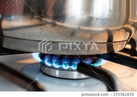 Saucepan on gas stove, gas cooker in the kitchen Saucepan on gas stove, gas cooker in the kitchen 133362839