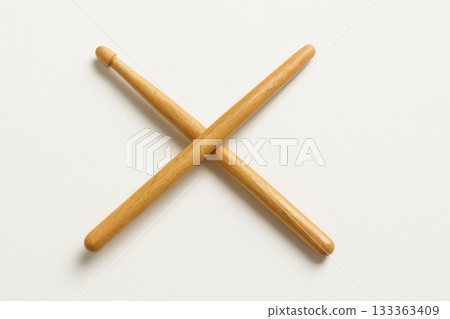 Wooden drumsticks crossed on white background for music practice 133363409