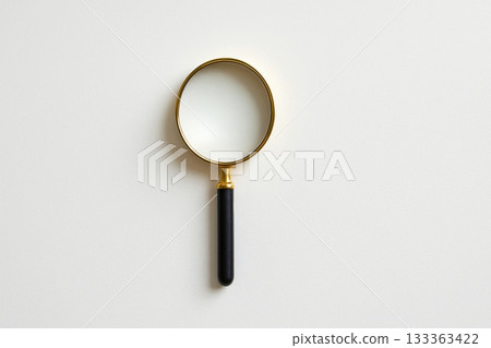 Magnifying glass with black handle on white background for close inspection 133363422