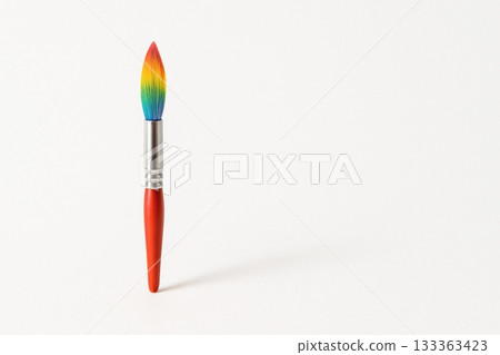 Rainbow paintbrush standing on white background for art and creativity 133363423