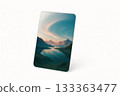 Tablet displaying mountain landscape with lake and sky reflection 133363477