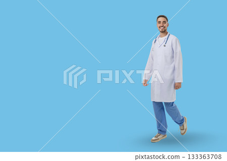 Health professional wearing a coat and stethoscope walks happily 133363708