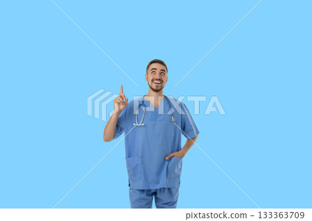 Doctor wears scrubs and smiles while sharing a positive message 133363709