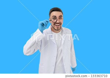 Doctor in a white coat enjoys examining with a magnifying glass Doctor in a white coat enjoys examining with a magnifying glass 133363710