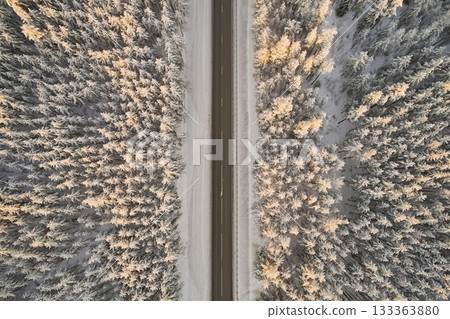 Aerial view of highway in winter forest. Aerial view of highway in winter forest. 133363880