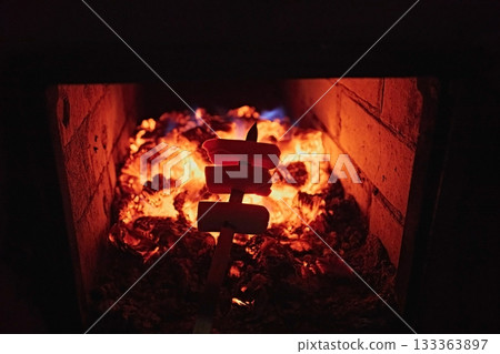 Cooking sausages on coals in the oven Cooking sausages on coals in the oven 133363897