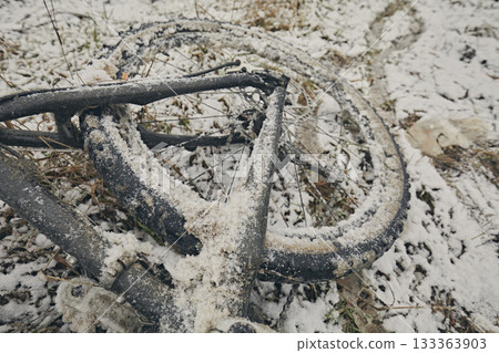 Bicycle in snow and mud in winter against the background of grass Bicycle in snow and mud in winter against the background of grass 133363903