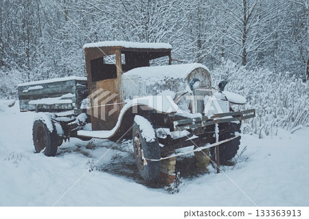 Military truck lorry of the times of the USSR against the backdrop of a winter forest Military truck lorry of the times of the USSR against the backdrop of a winter forest 133363913