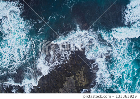 Aerial view of the waves in the Barents Sea near the shore, close-up view down 133363929