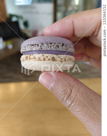Finger pinching taro macaron. 133364152