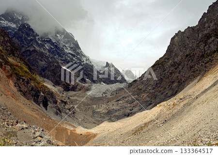 Chalaadi Glacier, ice, glacial flour, moraine, and snow in the Caucasus Mountains. Mestia, Svaneti, Georgia. Chalaadi Glacier, ice, glacial flour, moraine, and snow in the Caucasus Mountains. Mestia, Svaneti, Georgia. 133364517