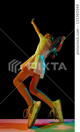 Female tennis player serving ball with emotion and physical intensity Female tennis player serving ball with emotion and physical intensity 133365049