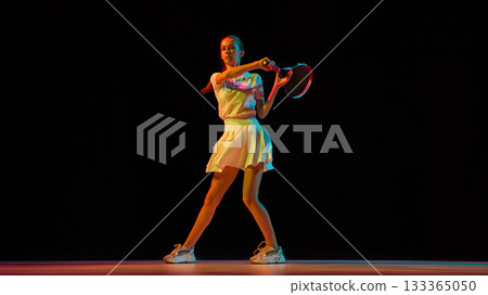 Female tennis player hitting forehand with strength and focus 133365050