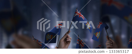 Cayman Islands flags in their hands on a blurred urban background Cayman Islands flags in their hands on a blurred urban background 133365317