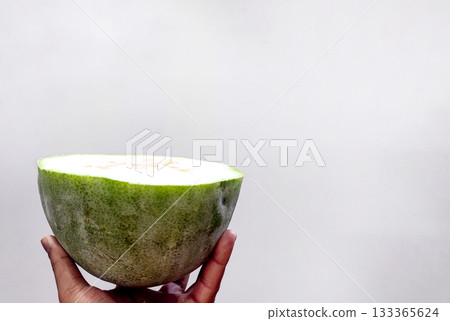 Half Cut Kaddu (Pumpkin) Held in Hand on White Background 133365624