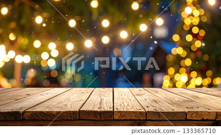 Vintage dark brown wooden plank tabletop with Christmas tree and glowing lights in an empty room interior 133365710