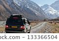 Off-road vehicle navigating rocky path in mountainous landscape 133366504