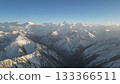 Snow-capped mountain range under clear blue sky with dramatic peaks 133366511