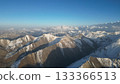 Snow-capped mountain range under clear blue sky with distant peaks 133366513