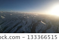 Snow-covered mountain range under bright sunlight with clear blue sky 133366515