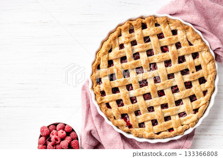 Classic American raspberry pie with napkin on white background. 133366808