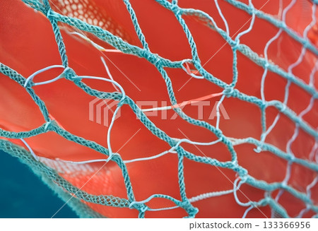 Blue fishing net covering a vibrant orange surface. AI Generated 133366956
