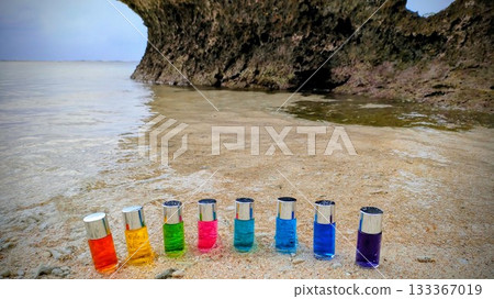 Healing colors! Colored bottles lined up on the shore / Natural light of the sea and sand / Tropical beach 133367019