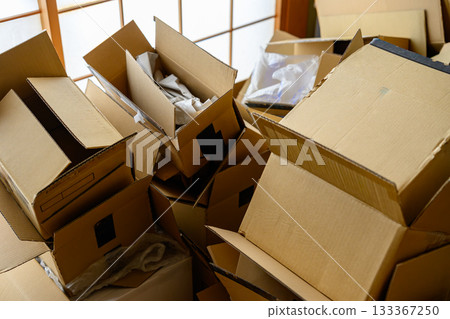 A room littered with opened cardboard boxes A room littered with opened cardboard boxes 133367250