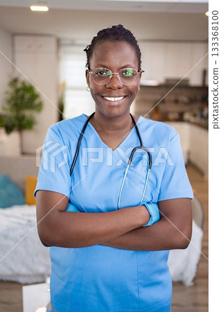 Confident healthcare professional smiling at home 133368100