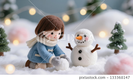 Christmas felt girl building snowman in snowy forest with fir trees and lights, handmade wool figure enjoying cozy winter holiday moment 133368147