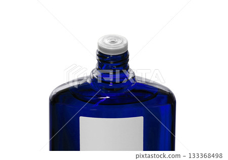 A blue translucent bottle of hair growth product with the screw cap open 133368498