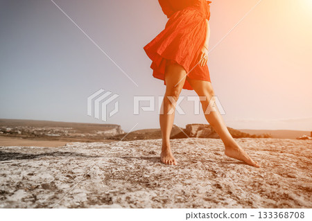 Woman in Red Dress Standing on a Cliff Woman in Red Dress Standing on a Cliff 133368708