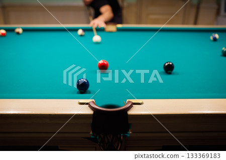 Billiard player at billiard table or snooker american billiards pool sport game. 133369183