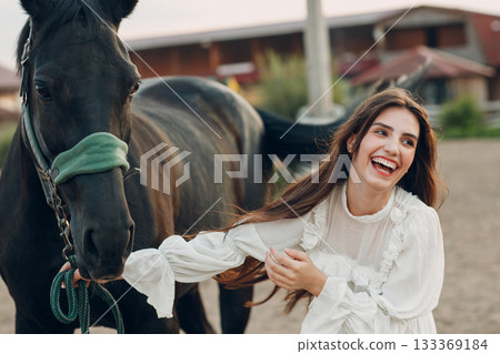 Woman with her horse at outdoors ranch Woman with her horse at outdoors ranch 133369184